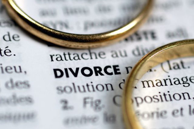 Two wedding rings placed on a dictionary page highlighting the word 'divorce', reflecting the complexities of divorce in Fort Lauderdale.